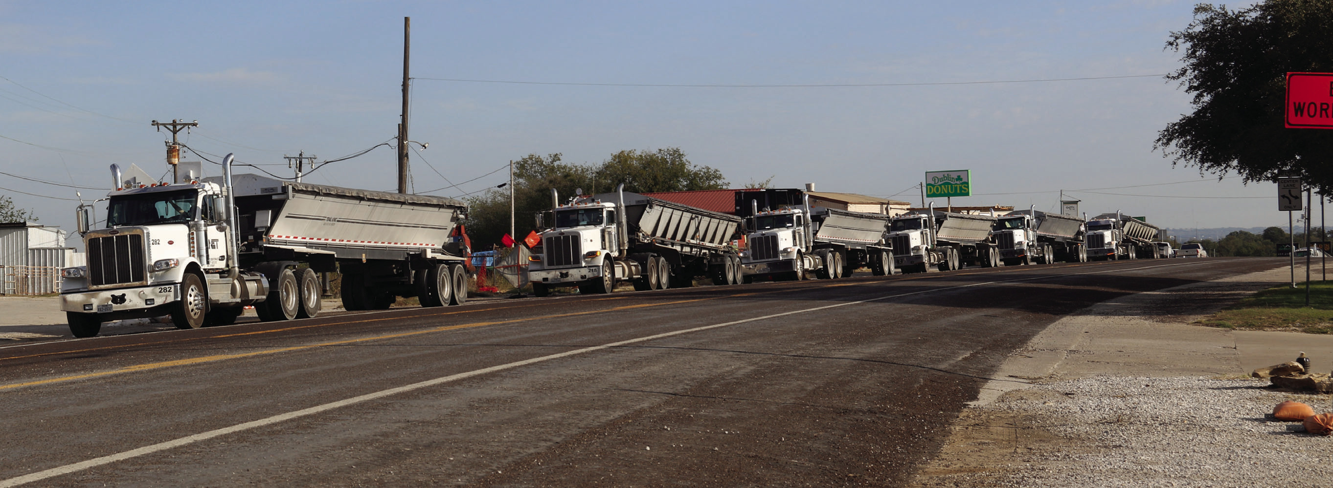 Wyndi Veigel-Gaudette | Citizen staff photo Right, a line of trucks wait to bring in materials for the Patrick Street project.