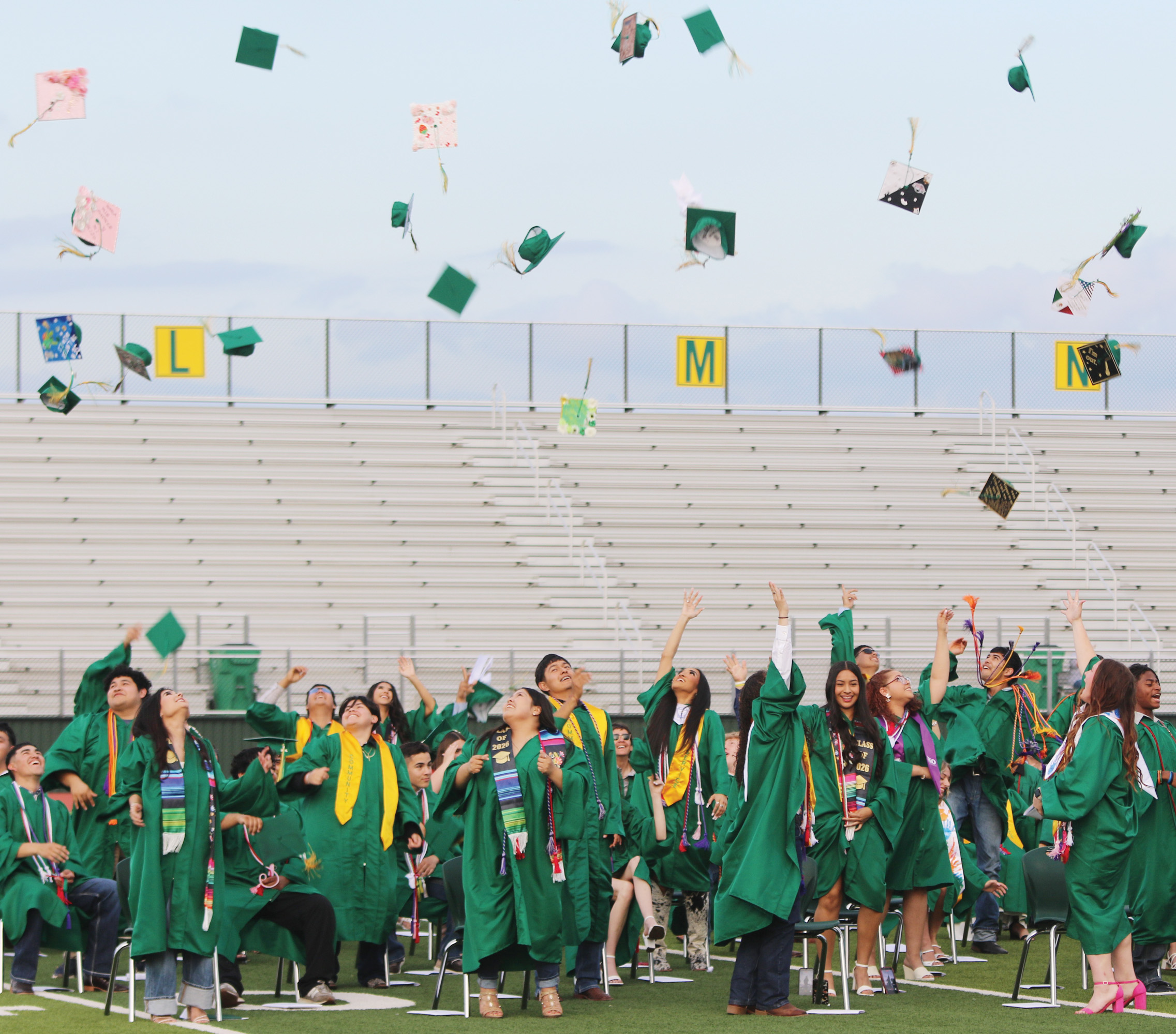 Graduates toss their hats in the air