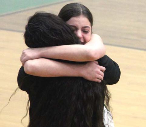 Madison Turley shares a tearful hug with coach Kim Perez after the final shot of her high school career. Paul Gaudette | Citizen staff photo