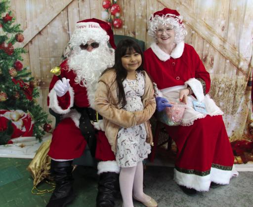 A young lady visits with Santa and Mrs. Claus at the CWJC Thrift store in Dublin Saturday, Dec. 13. Mrs. Claus visited with people while handing out Christmas cookies, and Santa checked his list ... twice. Wyndi Veigel-Gaudette | Citizen staff photo