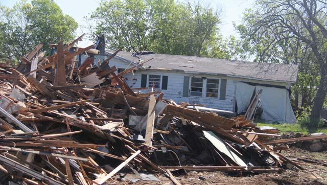 City crews work to eliminate condemned structures on Highland Avenue. The crews have also been busy finishing up two rounds of patching last month, using 22 tons of mix. They will start on a third round when the supplier has a summer mix ready. Paul Gaudette | Citizen staff photo