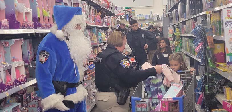 Above, Stephenville Police Department employees help a kid shop. Directly above, Blue Santa aids an Erath County Deputy in finding the perfect Barbie Doll during Shop with a Cop. More photos A4. Wyndi Veigel-Gaudette and Paul Gaudette | Citizen staff photo