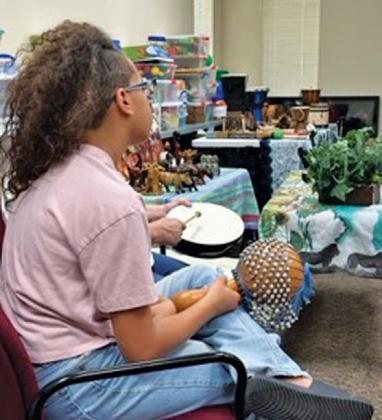 Participants in the Folktales from Africa program get to try out African instruments for themselves in the annual program. Submitted photo