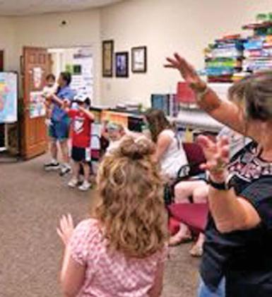 Kids participate in the African program, learning more about cultures from the continent and hearing folktales from Elizabeth Kahura who is from Kenya. Submitted photo