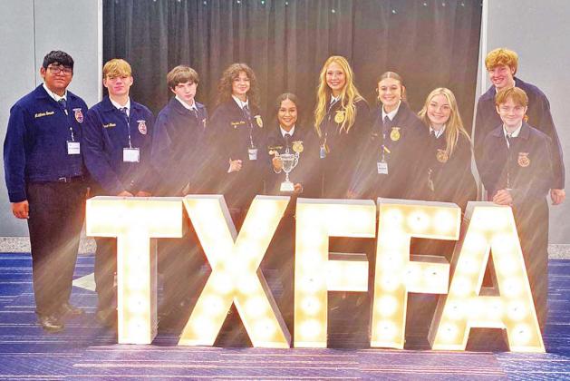 Dublin FFA members Jayden Rojas, Daniel Staud, David Greene, NavaLee White, Vanessa Pantoja, Bailey Watson, Jena Sorrells, Nicole Foster, Hayden Milburn and Paul Adams take time to bask in the bright lights at the Texas state FFA convention July 8-12 in Houston. The Dublin FFA program received several accolades during the event. | submitted photo
