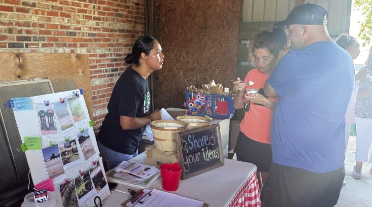 Abigail Delgado asks about community needs and speaks about the Hogg Foundation for Mental Health grant for Rural Healing through Innovation and Connection during the July 31 community event at the historic train depot. Paul Gaudette | Citizen staff photo