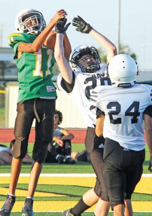 Paul Gaudette | Citizen staff photo Seventh grade Lions Jacob Marrett, Westin Rollins, Victor Vasquez and Kyler Gaitan pounce a Brady ball carrier in Thursday’s home game (above, left) while Jayden Balvantin leaps up to catch a pass. Eighth grade Lions Ruben Bustillos, Ivan Phelps and Jayden Deleon sweep in to tackle a Brady Bulldog (above, left). Deleon also got off the ground to catch a TD pass over the heads of a couple of Bulldogs.
