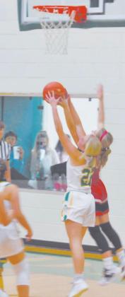 Dublin Lady Lion Naomi Dudley takes to the air to battle a visiting defender during a recent game in the Dublin Secondary School home gym. Paul Gaudette | Citizen staff photo