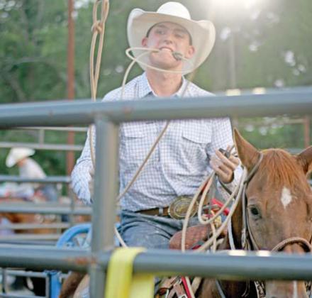 Left above, a youngster dismounts from a sheep during Mutton Bustin’ at the Saturday, Aug. 16 rodeo. A cowboy prepares to enter the calf roping competition during Saturday night’s rodeo hosted by Bryn Rodeo Productions. Arena. Wyndi Veigel-Gaudette | Citizen staff photo
