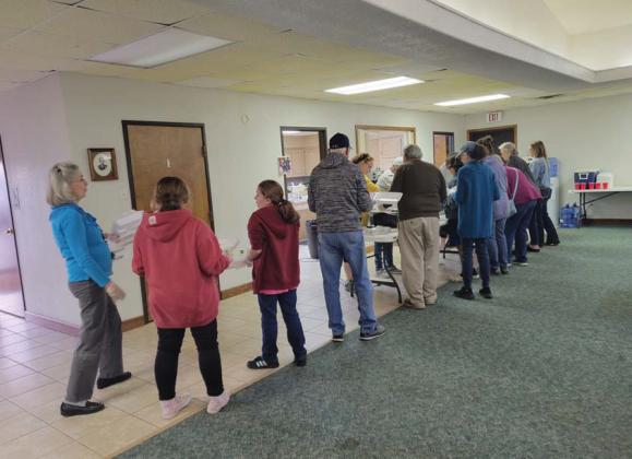 Volunteers line up to fill meal containers for the monthly Community Table outreach event. After 10 years of serving the community, the outreach will no longer be happening. Wyndi Veigel-Gaudette | Citizen staff photo
