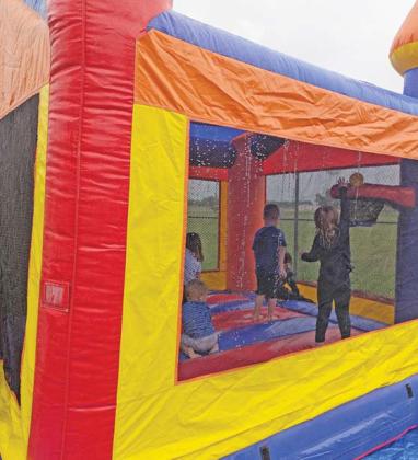 A damp bounce house from the Stephenville/Dublin KOA offers kids fun despite rainy conditions at the Saturday, April 19 EGGStravaganza. Paul Gaudette | Citizen staff photo