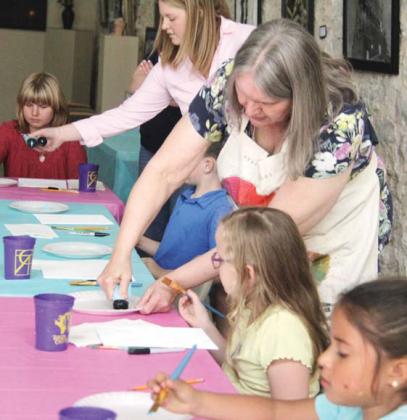Miss D and Cross Timbers Fine Arts Council staff help pour paint for young artists at the Hippity Hoppity Arts and Crafts event April 17 at the CTFAC Stephenville gallery. Kids were guided through several activities including a bunny painting on canvas, egg magnets and an accordian bunny. The creative workshop for kids was free to the community thanks to a grant from the Terrell Foundation. Wyndi Veigel-Gaudette | Citizen staff photo
