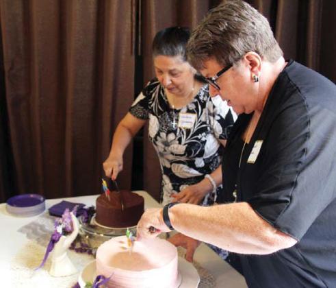 Wyndi Veigel | Citizen staff photo Thursday Club members Janet Pino and Edilsia Jimenez cut anniversary cakes at the club’s 125th celebration.
