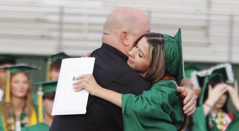 85 grads cross stage for new beginnings