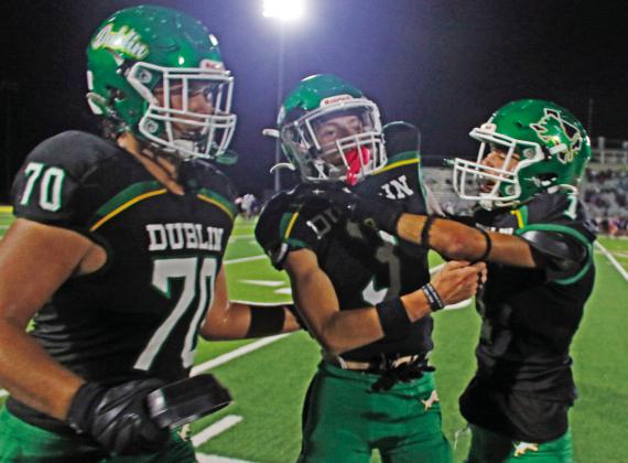 Dublin Lion Kyler Gaitan greets teammate Hudsen Joslin at the sideline with spirit after Joslin completes a catch and brings in 6 points for the home team on Cervetto Field Friday, Oct. 17. Jayden Balvantin also gives Joslin a pat on the back after completing the PAT kick. Paul Gaudette | Citizen staff photo