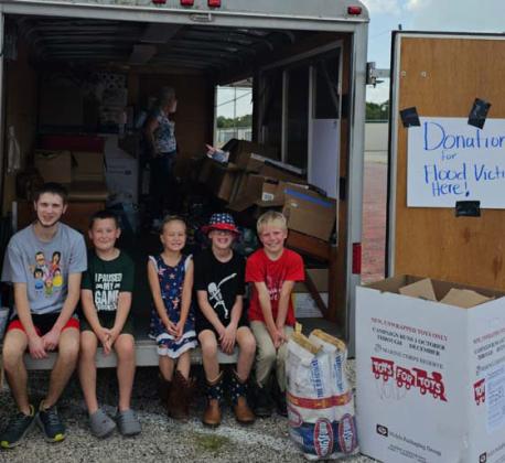 Kids from the Young Patriots of America members volunteer their time to help organize donations for flood victims. Courtesy photo