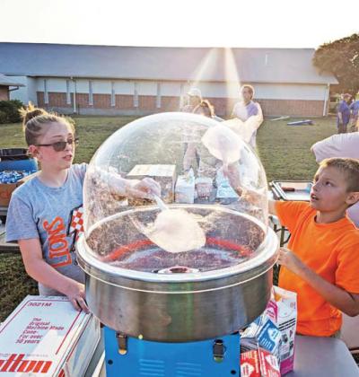 Kids make fluffy cotton candy at the Community Baptist Summer Social event. Paul Gaudette | Citizen staff photo