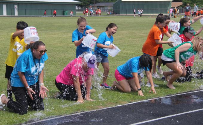 Teachers and administrators ‘enjoyed’ a nice ice bath May 17, 2023, at the Dublin Elementary School Field Day. All third grade students who were present during STAAR testing were entered into a raffle to be able to douse the educators with ice cold water. From left is Elementary School Principal Kalley Mitchell and teachers De’Ann Bradford,  Jessica Criswell and Leslee Chapman.