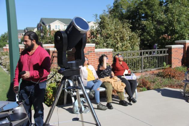 Students look at the annular solar eclipse Oct. 14, 2023, outside the science building at Tarleton State University in Stephenville. Many people throughout the area took the opportunity to see the partial coverage of the sun during the eclipse.