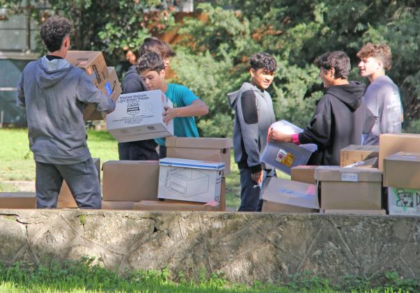 Dublin Lions from the boys athletic department helped carry out boxes and shelving in November 2023 as the Dublin Public Library got ready to close for a major renovation project that was underway.