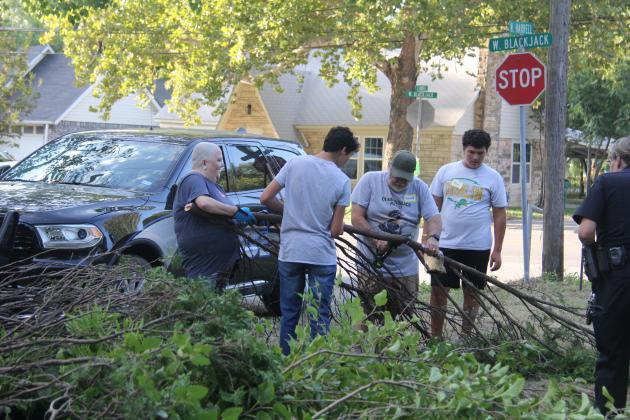 Dublin volunteers and Boy Scouts work to cut up a tree as part of Revitalize Dublin’s first project, a home in need of extensive yard work and TLC located on the corner Blackjack and Harrell.