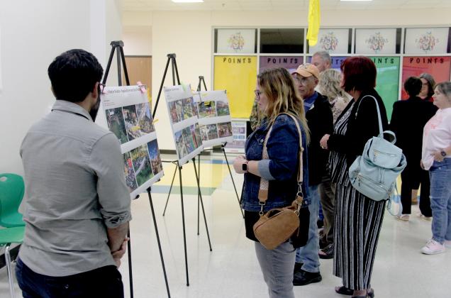Citizens review a wide variety of design boards at a community-wide dinner Sept. 23, 2024, at the Dublin Intermediate School in the feedback portion of the design workshop for Citizens’ Institute on Rural Design (CIRD). 
