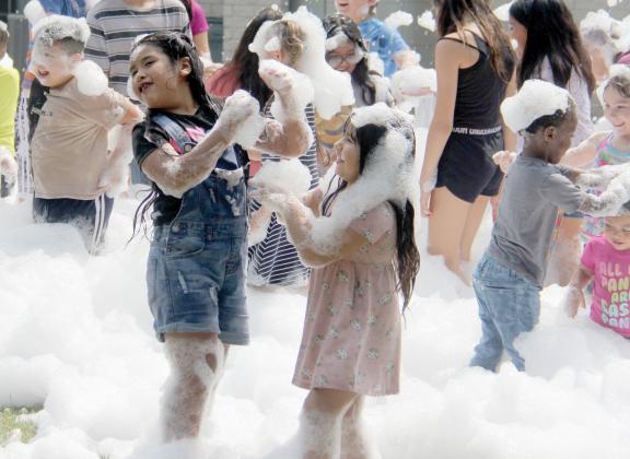 Sisters enjoy playing in a giant foam pile at the annual Back to School Fair at the Dublin Public Library July 27, 2024. The event offered free backpacks, toiletries and more for students and parents getting ready for school.