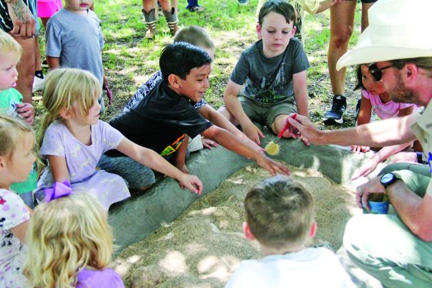 Kids of all ages enjoy digging into some dino fun at the Dublin Public Library June 27, 2024, with Park Rangers from Dinosaur Valley State Park in Glen Rose. Students and adults alike got to hear about fossils found at the park, unearth some fossils outside and enjoy some popsicles courtesy of library staff.