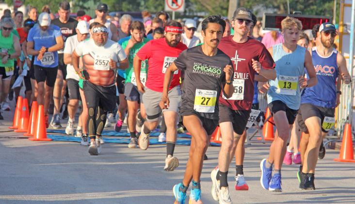 Runners in the Lions Club Irish Stampede 5K and 10K rush through the gate June 8, 2024.