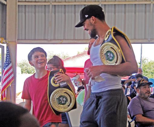 Boxers hold winning belts as they exit the annual Lights Out Boxing Tournament held by Stephenville Boxing Club at the annual Dublin Chamber of Commerce Hispanic Heritage Festival at the Dublin City Park Sept. 21, 2024.
