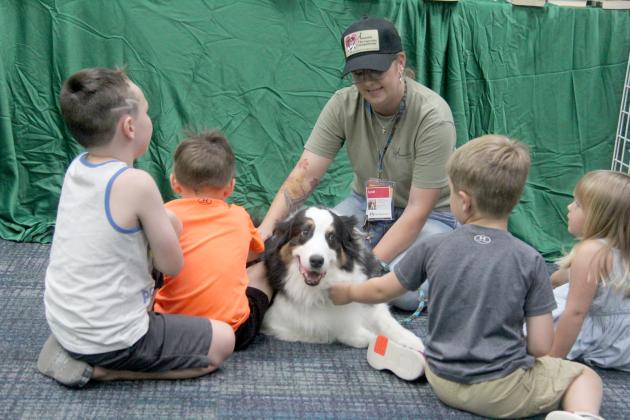 Lyndi Hanna and Hank of Annie Therapeutic Companions teaches kids at Dublin Public Library about the need for registered animal therapy teams. The program, organized by Lyndi, showcased working dogs including a K9 officer, a therapy dog and an arson detection dog July 11, 2024, as part of special programs for the Summer Reading Club.