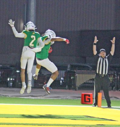 Dublin Lions Alex Teten and Francisco Garcia go airborne in celebration as a ref signals that Gracia successfully caught a pass from quarterback Kaden Gaitan for a touchdown Oct. 25, 2024, on Cervetto Field. The Lions won the game over the Eastland Mavericks 35-28.