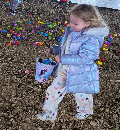 A little girl in a puffy coat.