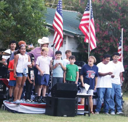 A crowd of kids and adults lead attendees of the July 3rd Dublin Celebrates America250 celebration at Dublin Public Library in the singing of some patriotic favorites.