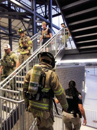 Above, Sheriff Matt Coates and more than 50 first responders climb more than 9,000 stairs in a 9/11 Stairclimb at Art Briles Stadium in Stephenville. The climb is representative of the sacrifice made by first responders killed during the 9/11 terroristic attacks at the World Trade Center. Below, a flag flown over NYPD headquarters is folded with honor at a 9/11 25th anniversary ceremony. Wyndi Veigel-Gaudette &amp;amp; ECSO | Citizen staff photo