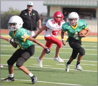 A 7th-grade Dublin Lion moves the ball around Albany defense as a teammate blocks in the front. Dublin fell to the visitors in the opening game of the season 38-14 as the Dublin boys hit the Cervetto Field turf on Thursday, Aug. 31. Paul Gaudette | Citizen staff photo