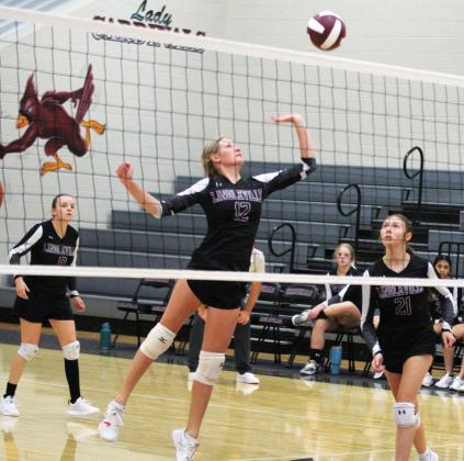Lingleville Lady Cardinal Madison Howle springs up to return the ball to Iredell during a Sept. 10 game in the Lingleville gym. The home team claimed the victory, winning all three sets. Paul Gaudette | Citizen staff photo