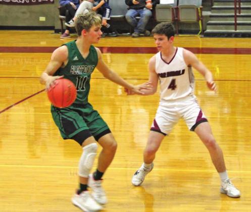 Lingleville Cardinal Kyler Philips moves to block an advancing Bluff Dale Bobcat during Friday’s home game. Sara Gann | Citizen staff photo