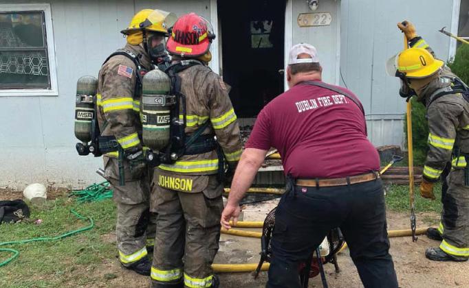 Firefighters work to save a mobile home on Myrtle Street. A family of seven has been displaced after the fire and is seeking donations. Courtesy photo