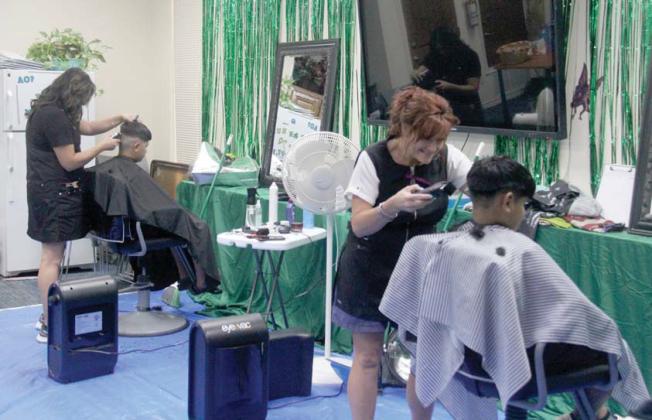 Paul Gaudette | Citizen staff photo Lindsay Moore of Sheer Heaven and Blanca Lopez of All About You Salon donate free haircuts as part of the Back to School Fair.