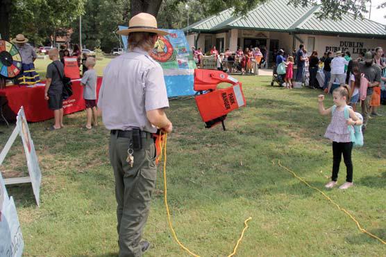 Paul Gaudette | Citizen staff photo Left, kids toss life jackets in the ‘Save the Ranger’ game courtesy of Proctor Army Corps of Engineers.