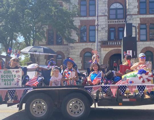 Dublin Girl Scouts wave at the crowd while participating in Stephenville’s July 4th parade. Courtesy photo