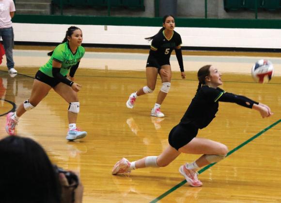 Dublin Lady Lion Addisen Zimmerman digs for the ball against Hico Friday Aug. 22 while teammates Yasmin Esparza and Sandra Vasquez move in to assist. Paul Gaudette | Citizen staff photo