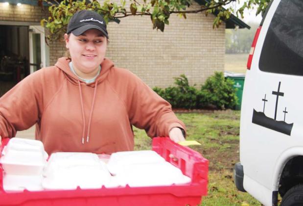 A volunteer from the Church for the Lost and Found - First Assembly of God loaded up meals on Thanksgiving Day to deliver for Meals on Wheels recipients. Paul Gaudette | Citizen staff photo