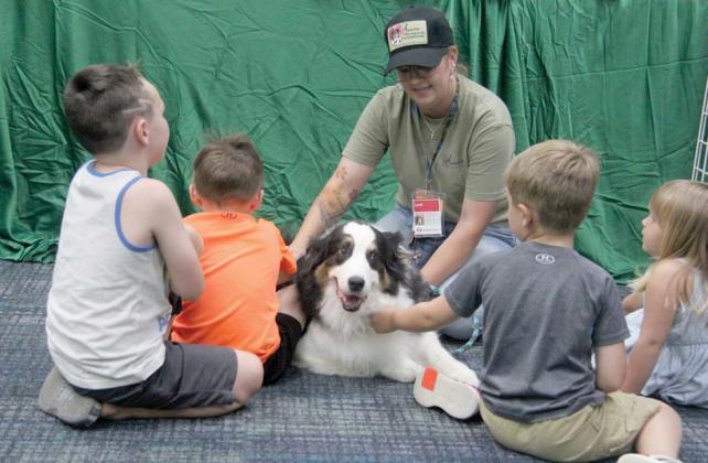 Lyndi Hanna and Hank of Annie Therapeutic Companions teaches kids at Dublin Public Library about the need for registered animal therapy teams. The program, organized by Lyndi, showcased working dogs including a K9 officer, a therapy dog and an arson detection dog Thursday, July 11 as part of special programs for the Summer Reading Club. Wyndi Veigel-Gaudette | Citizen staff photo