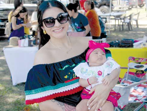 A mom and daughter enjoy some shade at the annual Hispanic Heritage Festival. Wyndi Veigel-Gaudette | Citizen staff photo