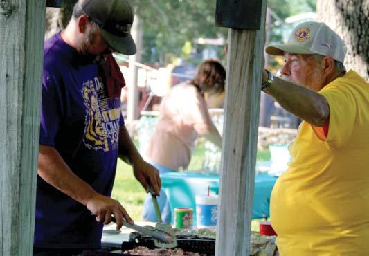 Dublin Market Days patrons visit with Cornerstone Christian Education of Eastland (above) at Wright Park Saturday, July 19. The farmers market also includes sellers of homemade goods including knives (left) and the Dublin Lions Club who were selling pulled pork tacos and sandwiches as a fundraiser as well as tickets to the raffle being held at the Dublin Public Library’s Back to School Fair Saturday, July 26 from 10 a.m.-1 p.m. Paul Gaudette | Citizen staff photos