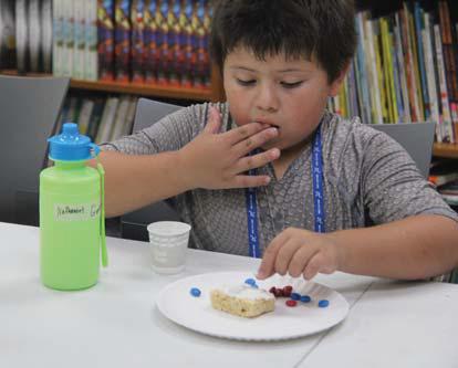 Star Council Community Coalition Coordinator Chris Langer reads to kids at the Dublin Public Library for the Bosque Little’s Camp Thursday, June 6. Below, kids enjoy playing games and making patriotic snacks. Wyndi Veigel-Gaudette | Citizen staff photos