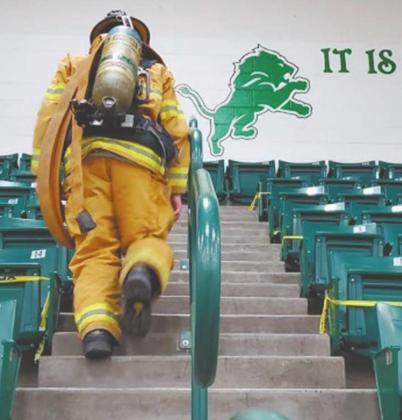 Jonathon Weiss donned 75 pounds of firefighter gear to take the 2,071 steps in solidarity with the firefighters who would have had to climb that much to reach the top of the World Trade Center on Sept. 11, 2001. Weiss helped organize a climb for the Dublin Cross Country team on Thursday. | submitted photos