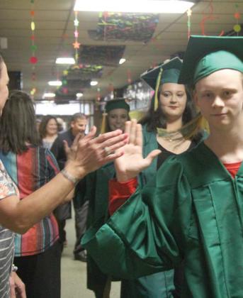 Seniors make their way through the Dublin Elementary School hallways in their caps and gowns. Wyndi Veigel | Citizen staff photo